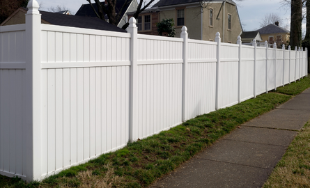 white fence along sidewalk