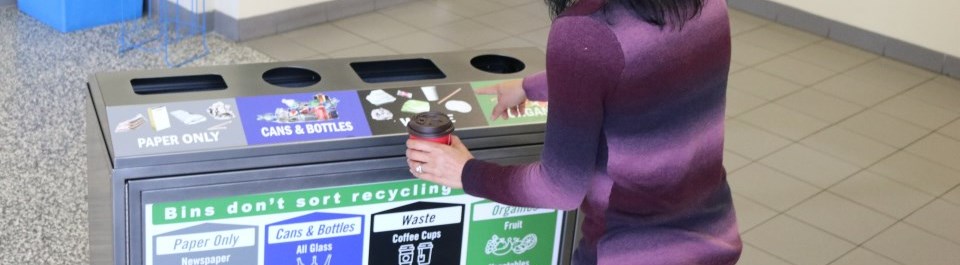 a facility user point at a waste receptacle, choosing which waste slot to use