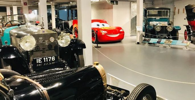 Disney Pixar's Lighting McQueen racing car and old heritage car in foreground