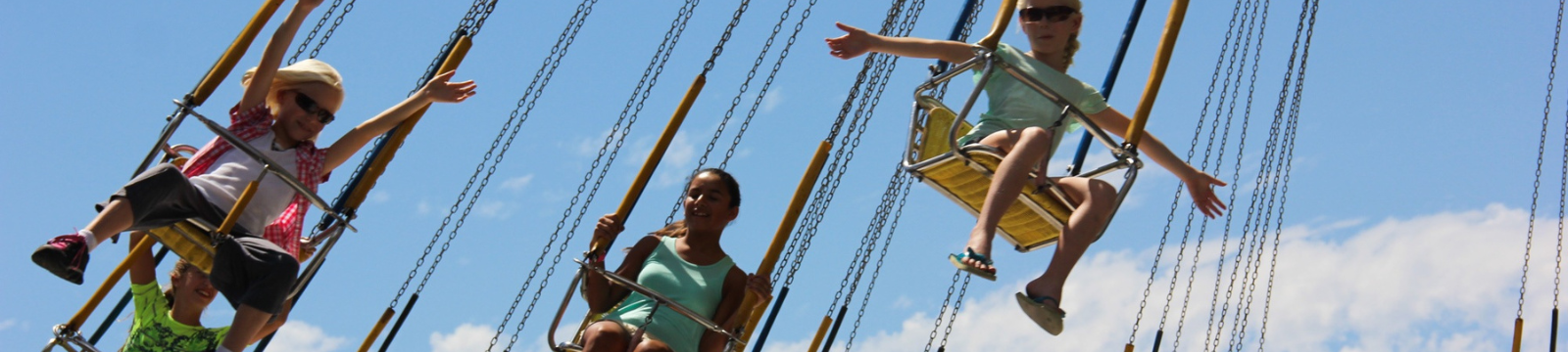 Children and adults on swing carnival ride