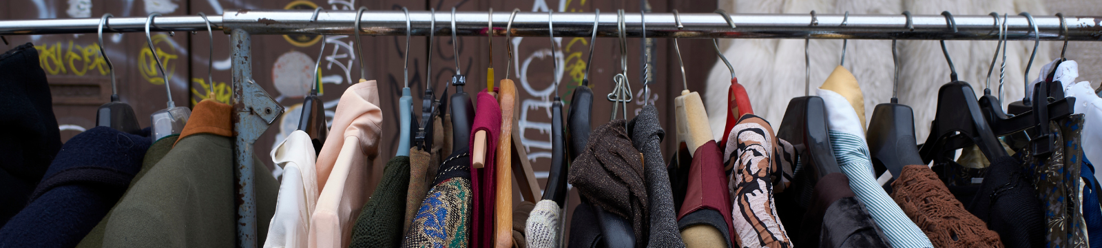 second hand clothing hanging on rack