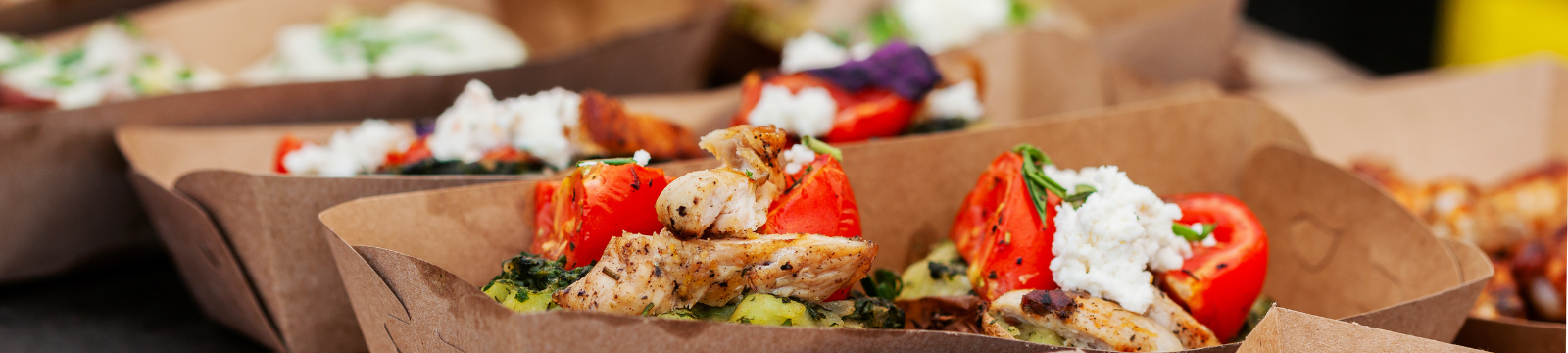 Variety of food in take away boxes