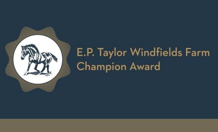 A drawing of a horse in a circular badge with the words E.P. Taylor Windfields Farm Champion Award to the right of the badge