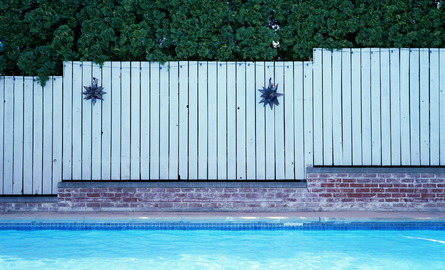 white fence around inground pool