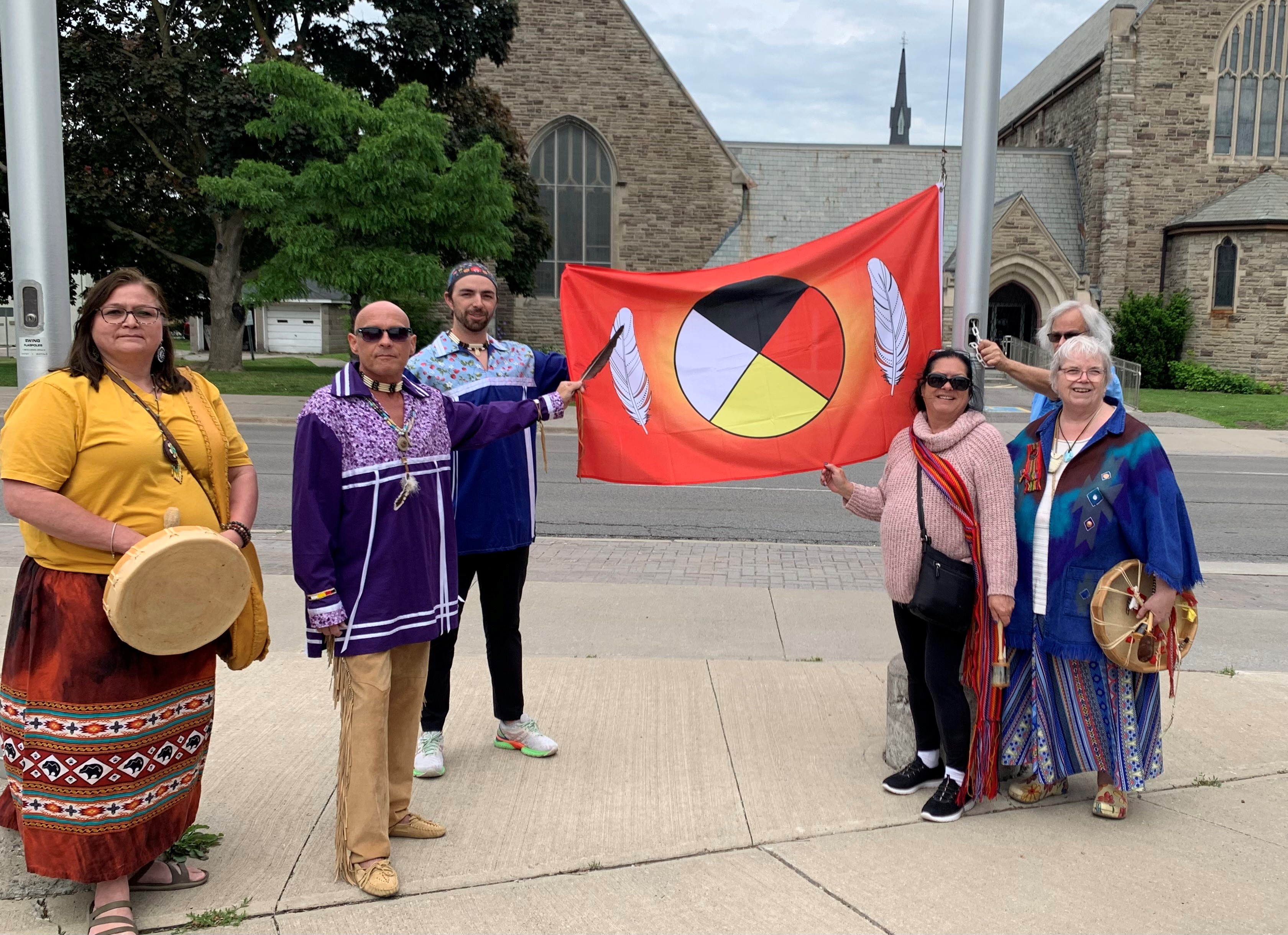 Community members raising the Medicine Wheel Flag in Oshawa Civic Square
