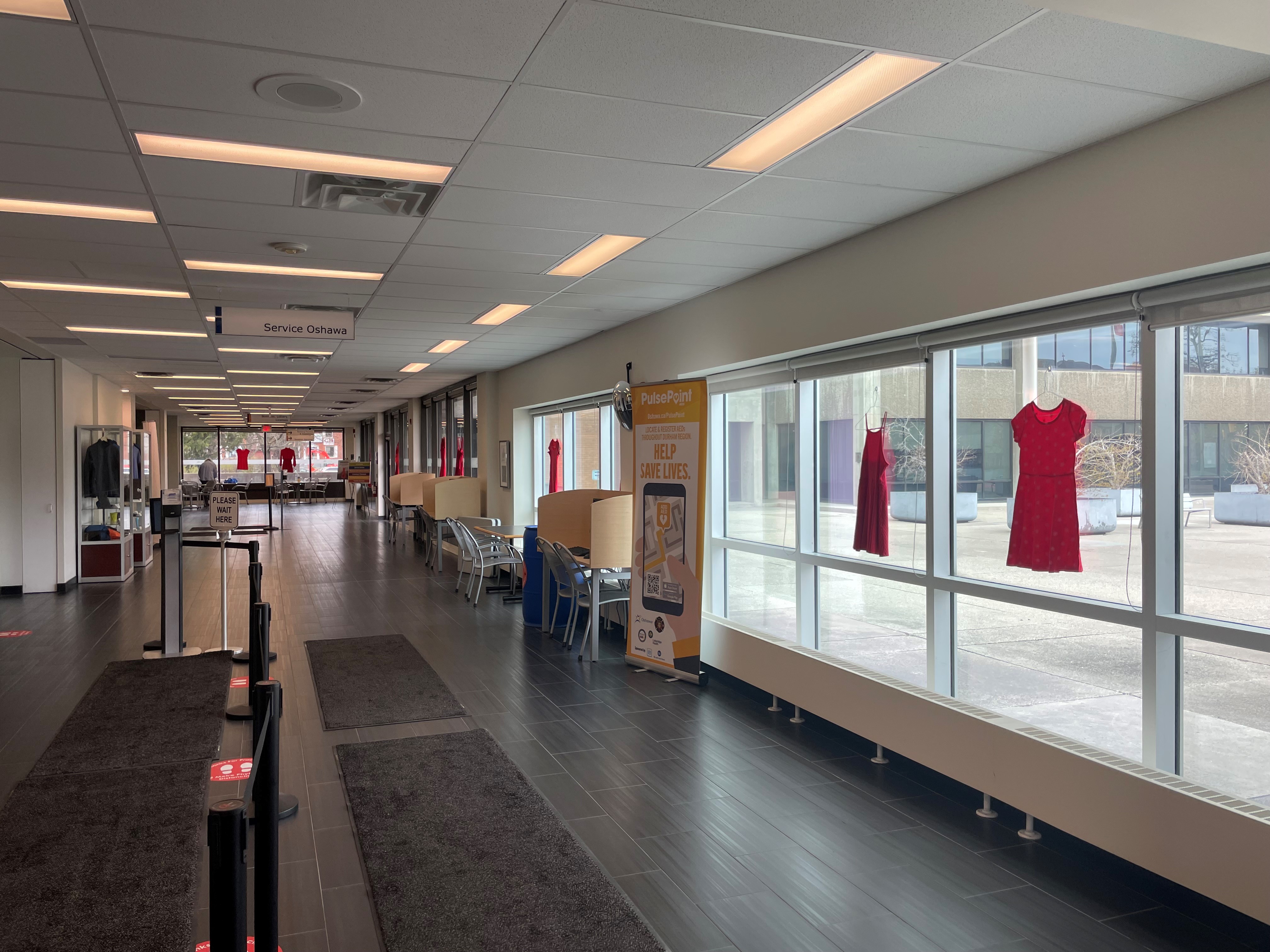 Image of Service Oshawa Hallway with red dresses lining the windows for reddress day