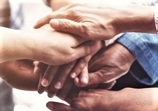 people's hands stacked