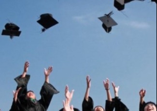 students tossing graduation caps