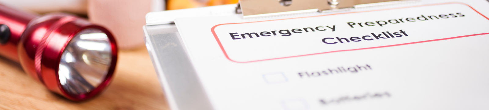 Emergency preparedness checklist and flashlight