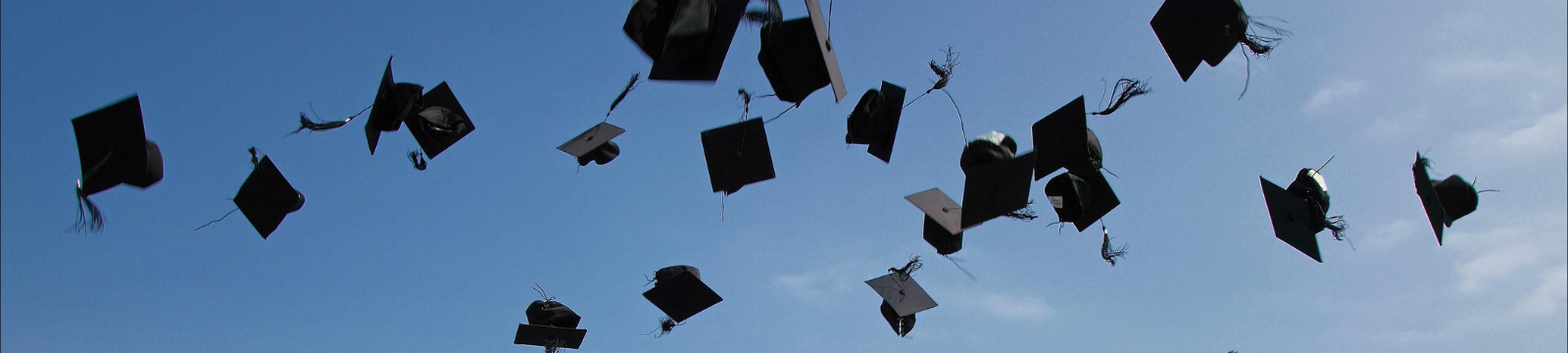 Graduation caps in the air