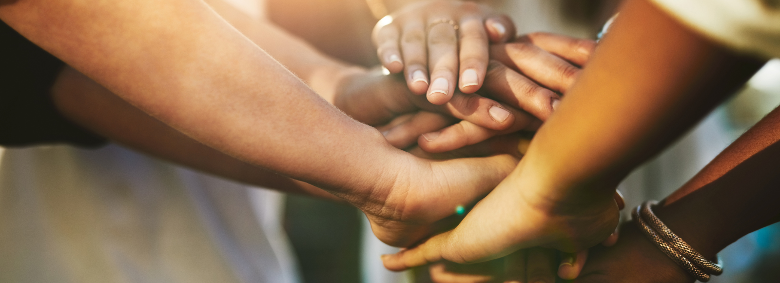 hands piled up to make a team