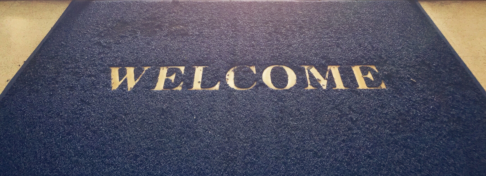 Welcome mat at entrance to building