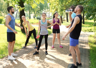 Young adults standing on a park trail