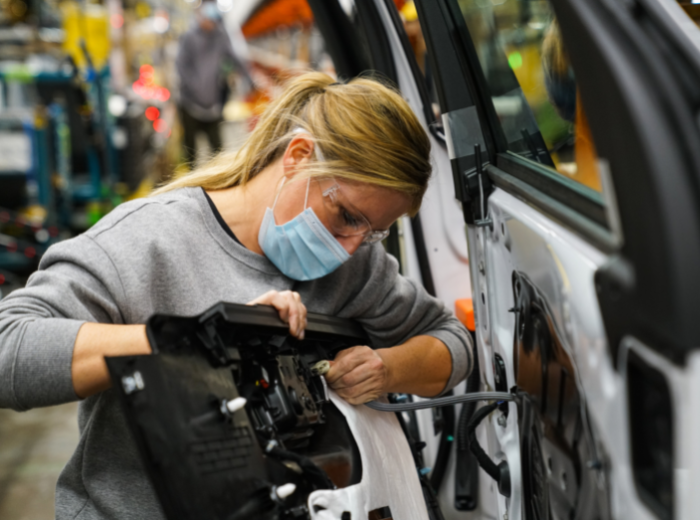 GM working on assembly line.