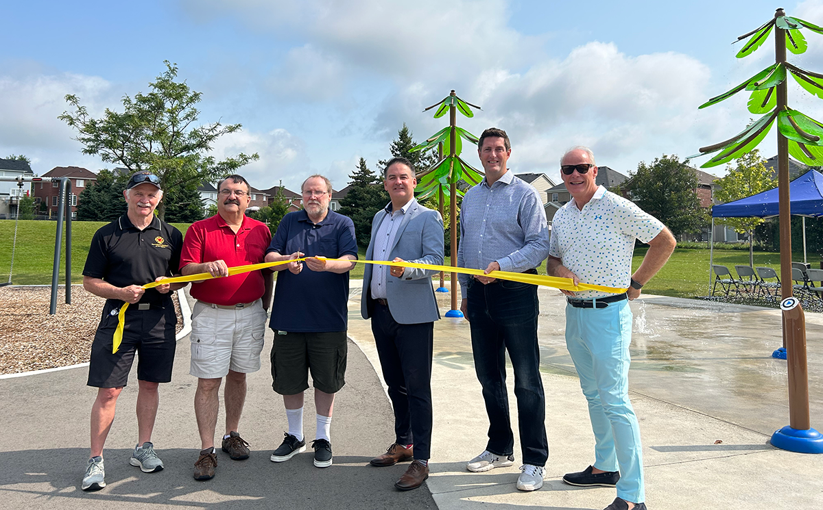 Ryan Turnbull, Member of Parliament for Whitby, on behalf of the Honourable Sean Fraser, Minister of Housing, Infrastructure and Communities, with members of Oshawa City cutting the ribbon in Pinecrest Park.