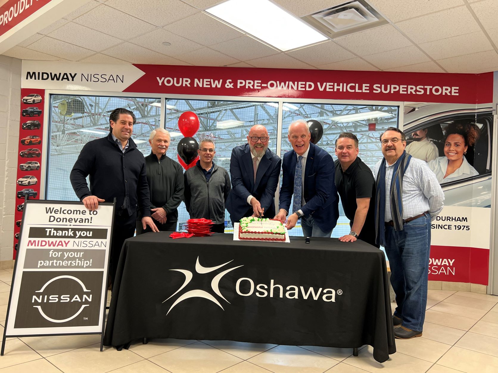 Members of Oshawa Council join representatives from Midway Nissan in celebrating the extension of their naming rights sponsorship of the arena at Donevan Recreation Complex for another five years. 
