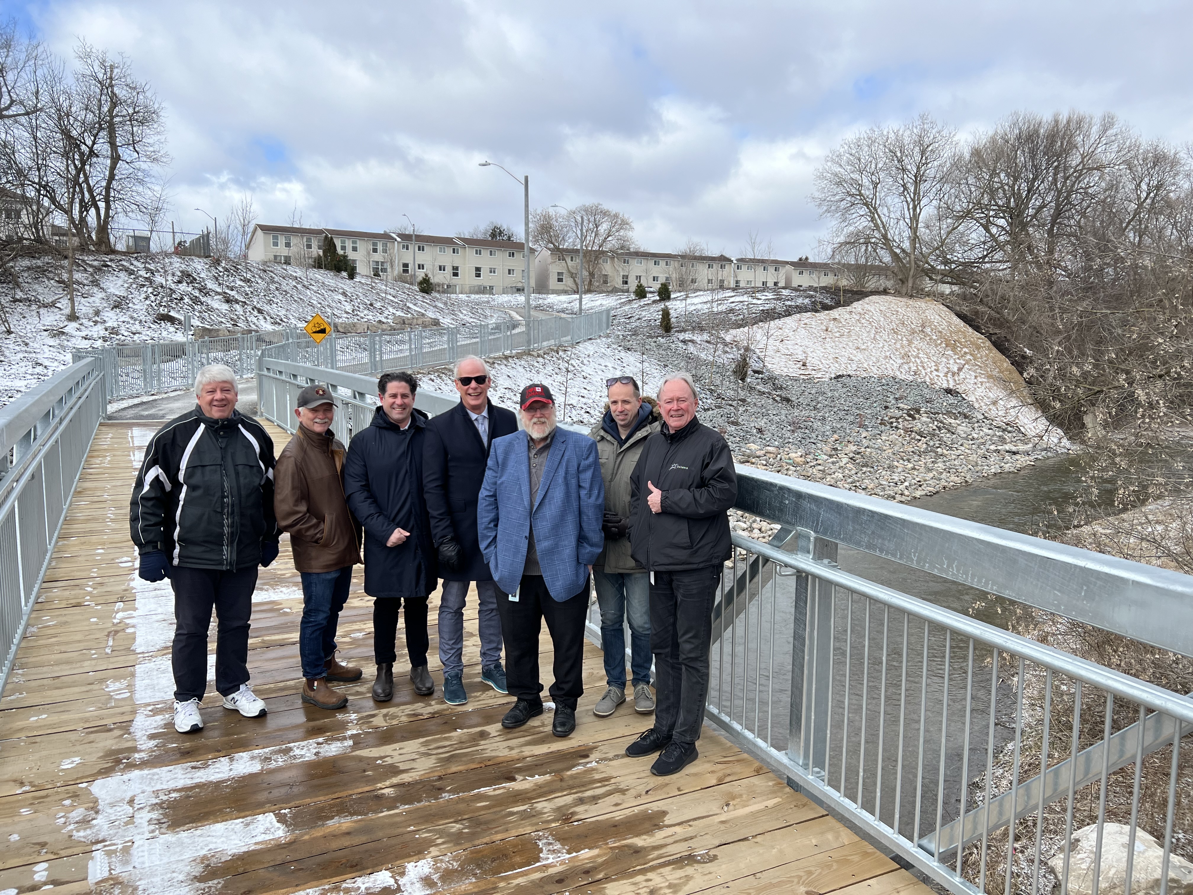 Members of Council at the newly constructed pedestrian bridge in Erie Park, from left – Ward 5 City Councillor John Gray, Ward 2 City Councillor Jim Lee,  Ward 2 Regional & City Councillor Tito-Dante Marimpietri, Mayor Dan Carter, Ward 5 Regional & City Councillor Brian Nicholson, Ward 4 City Councillor Derek Giberson and Ward 4 Regional & City Councillor Rick Kerr.