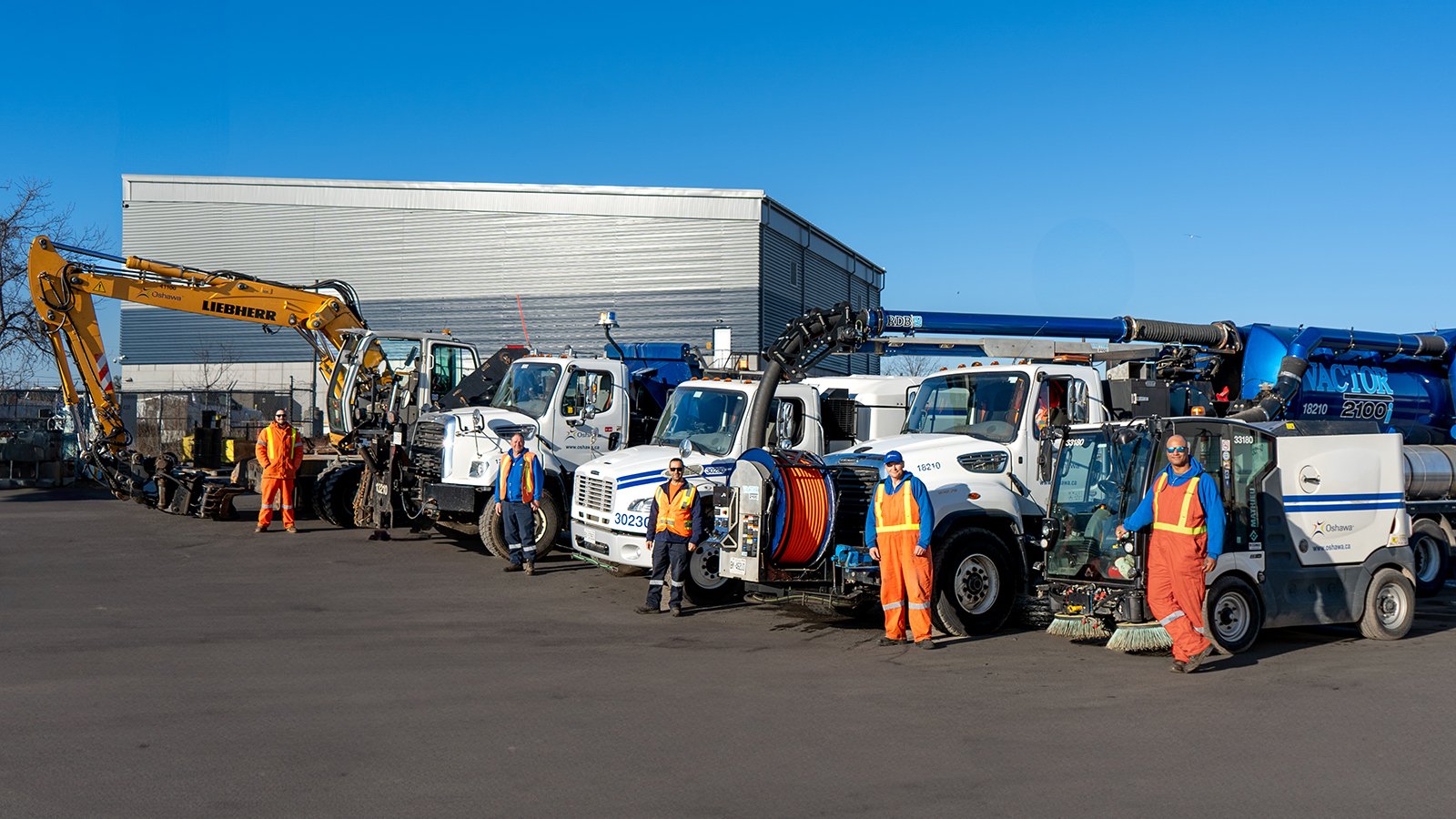 Public Works at Work: City staff standing with vehicles