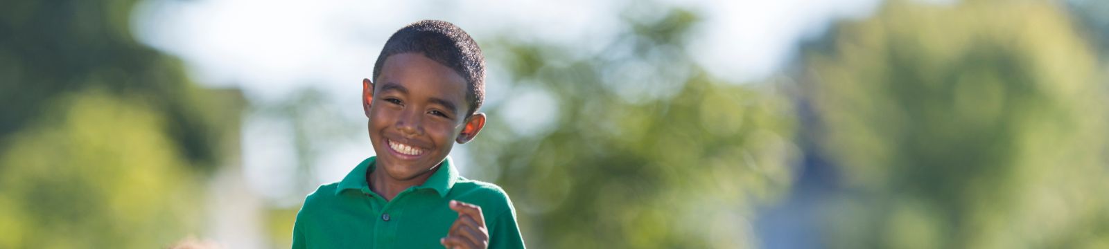 Boy smiling in a field