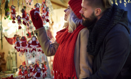 couple shopping at a holiday vendor tent