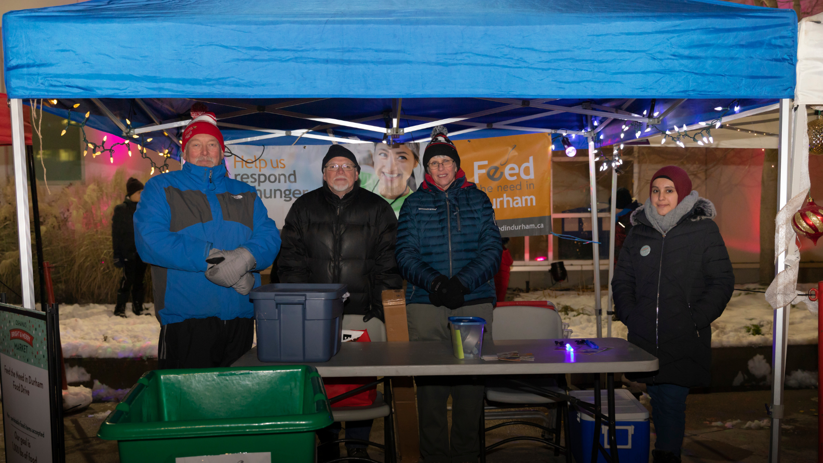 People under a tent at a table accepting donations
