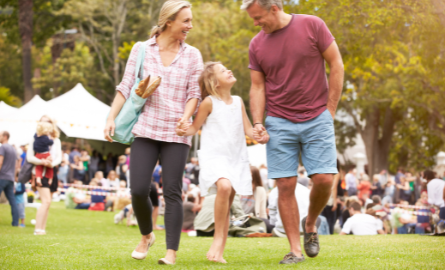 Family walking through event holding hands