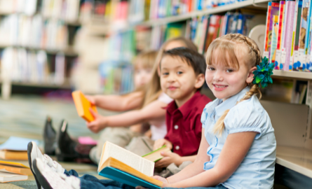 children sitting on floor in library