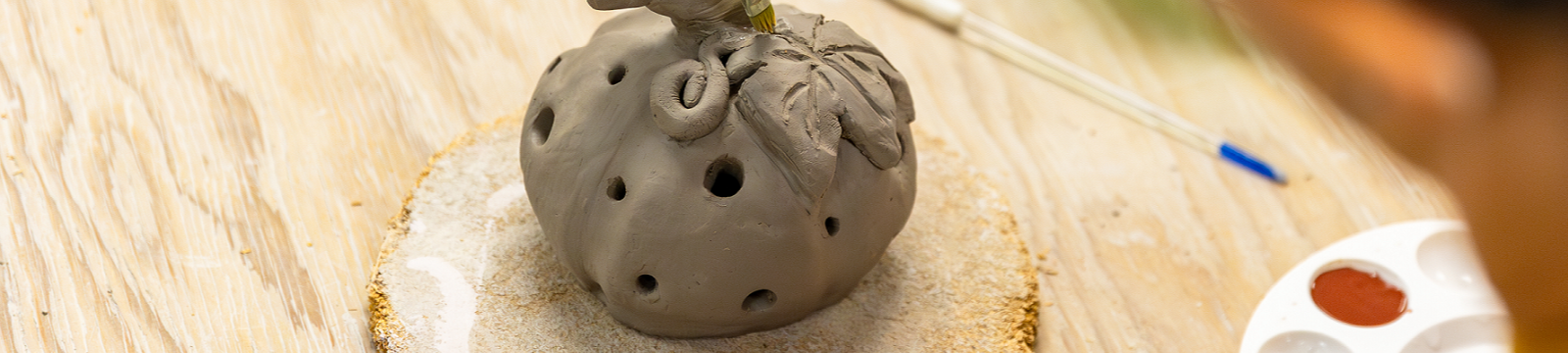 Clay pumpkin being made in a pottery class