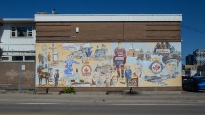 This mural depicts highlights from Oshawa's history, including the McLaughlins, Girl Guides, The Ontario Regiment, etc.