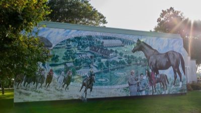 The mural depicts scenes of horse racing and Northern Dancer receiving roses after winning the Kentucky Derby