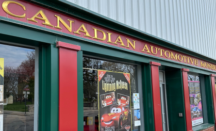 Exterior street side front of building and windows with Canadian Automotive Museum signage.