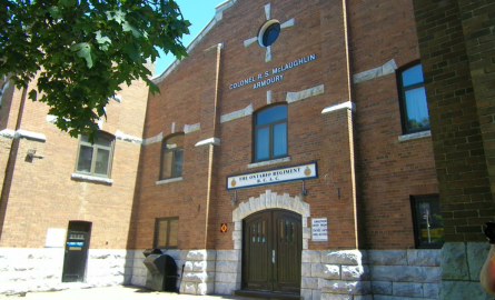 Historic military armouries, brown brick building showcasing main door.