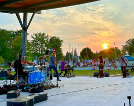 reverse photo of band playing on stage with audience