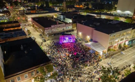 Aerial view of downtown Oshawa during a concert on King Street - with a stage and a large audience