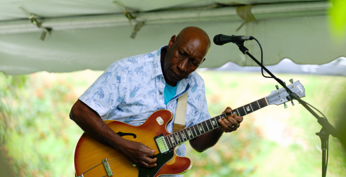 man playing guitar on stage