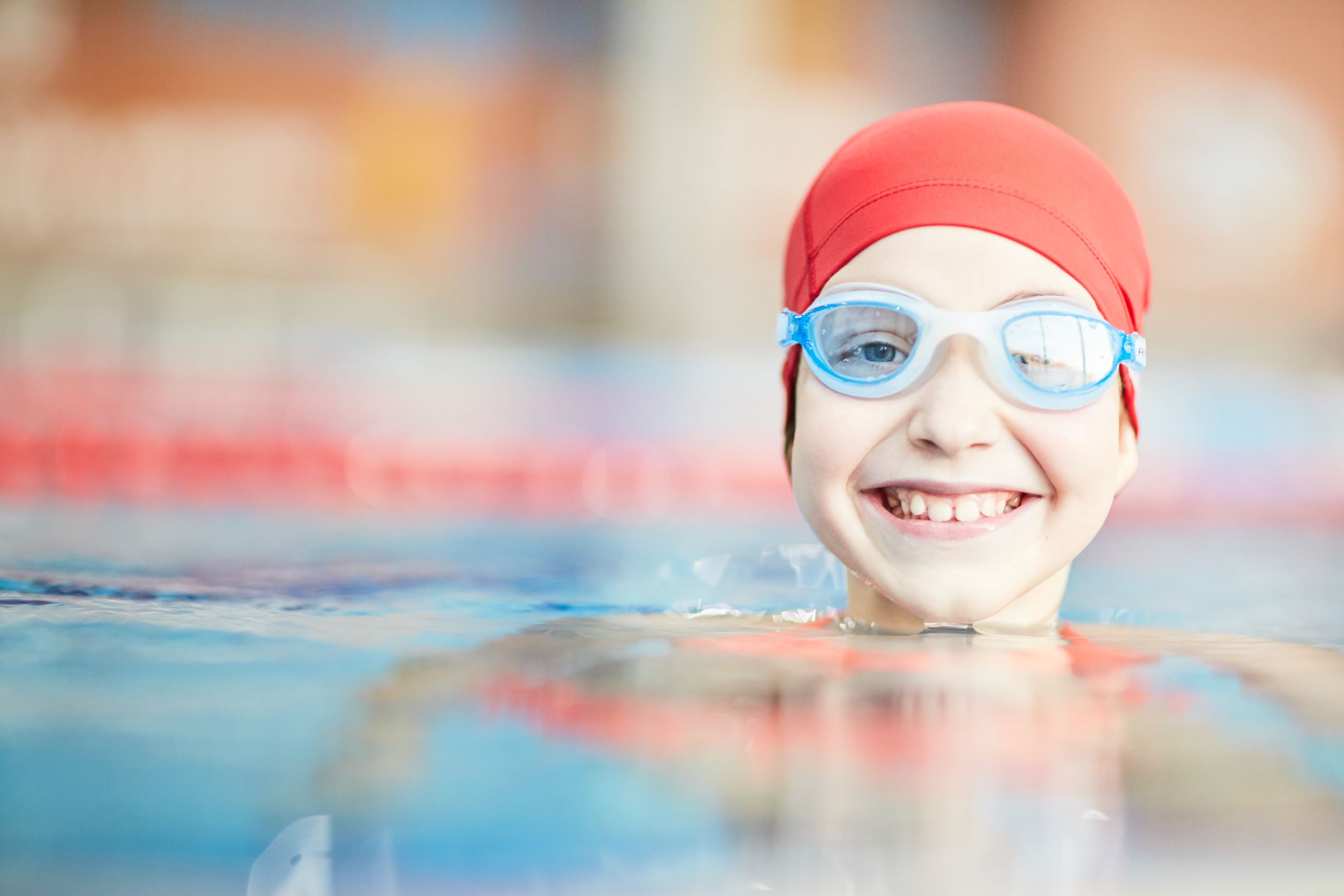 Girl with swimming cap and googles in pool