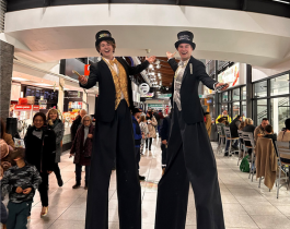 two stilt walkers wearing New Year's outfits