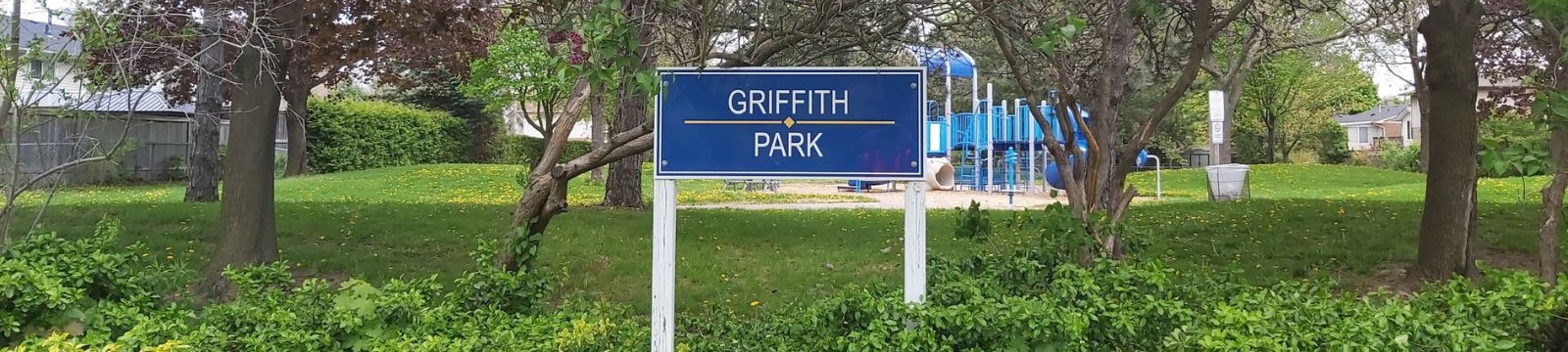 Image of park sign surrounded by shrubs