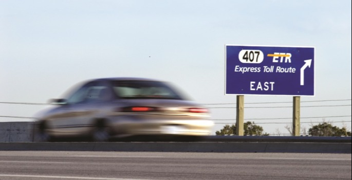 407 Highway sign with car speeding by