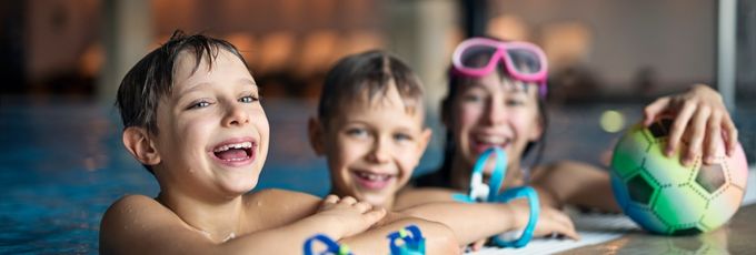 Children smiling in a pool