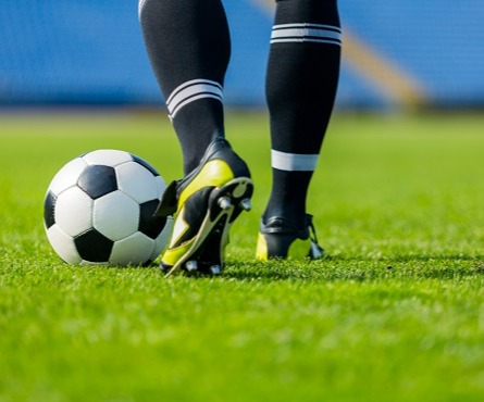 A person kicking a soccer ball