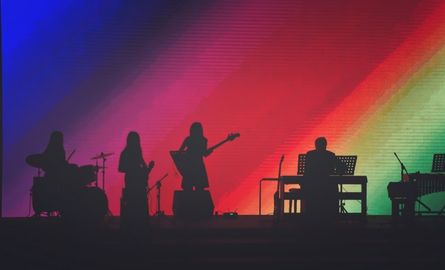 Silhouette of a band with a colourful background