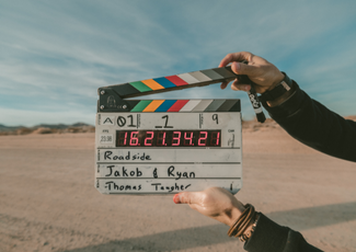 Hands holding a filming sign