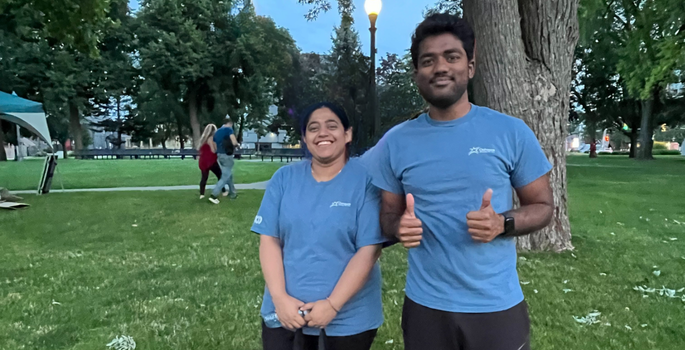 two volunteers standing in a field