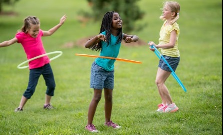 Three girls playing with hoola hoops