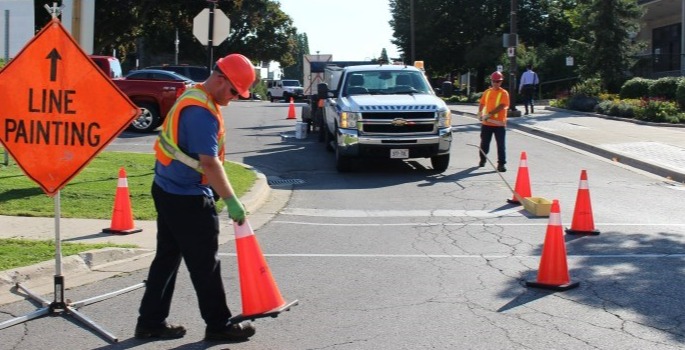 City staff painting lines on the roadway