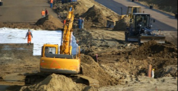 A backhoe doing roadwork