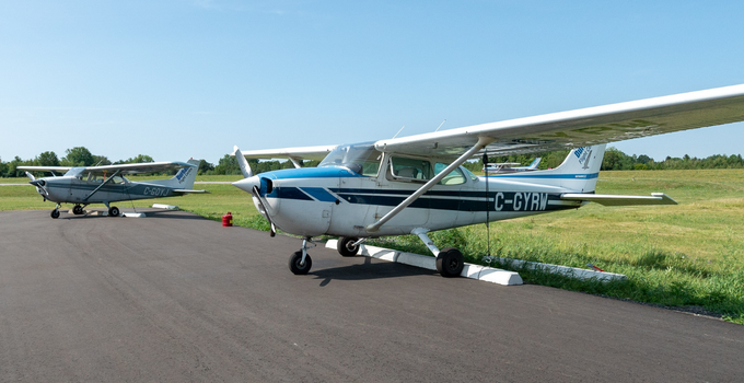 two airplane parked at the Oshawa Executive Airport