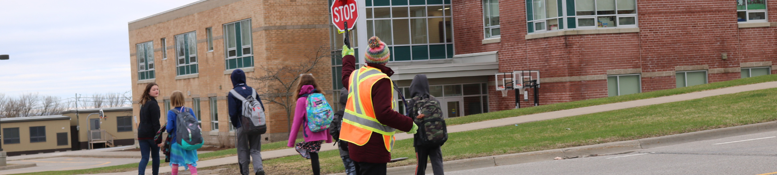 Crossing guard helping kids cross the street