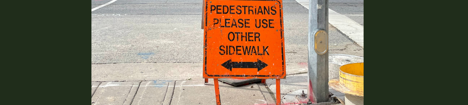 Sign indicating a sidewalk closure.